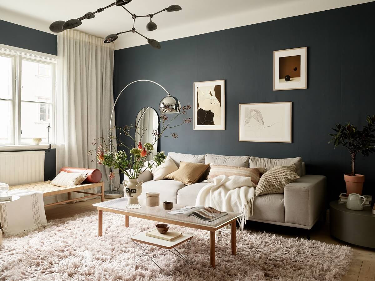 A Swedish Apartment with a Dark Blue Living Room and Exposed Brick 3 light and dark scandi living room