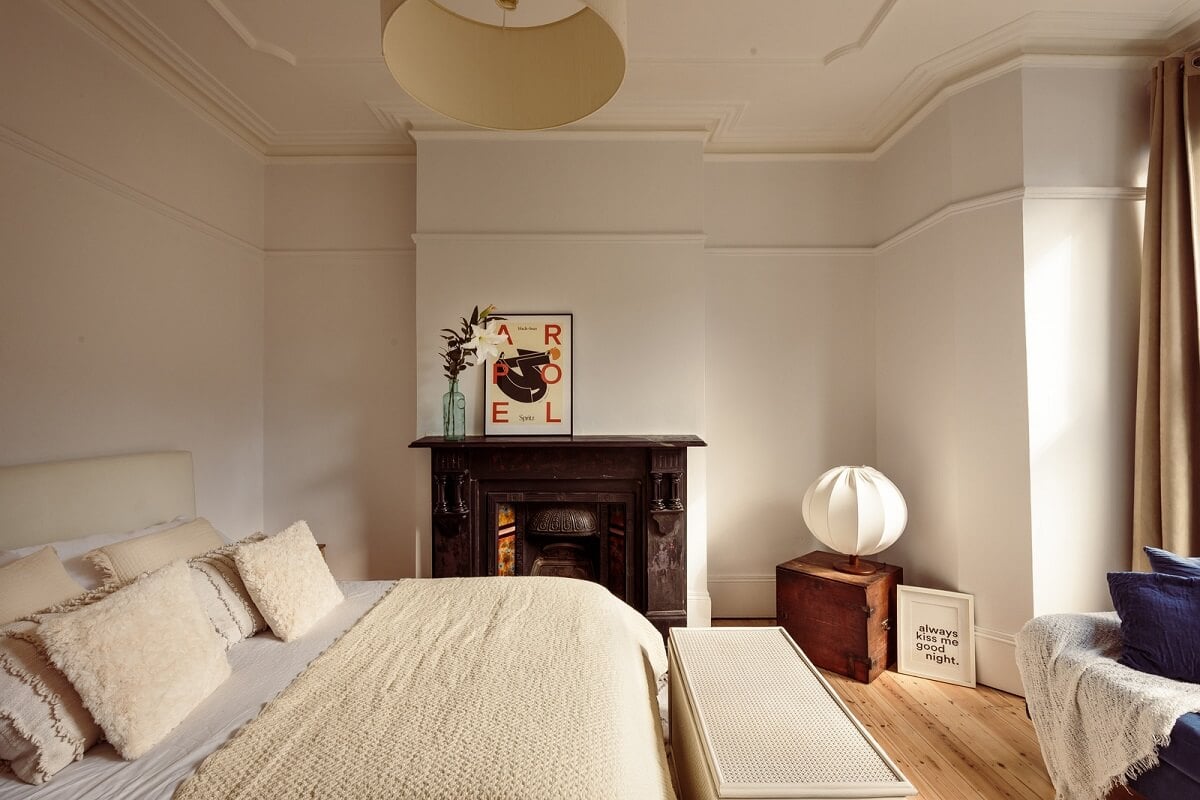 A Warm Ground Floor Apartment with Reclaimed Materials 19 light bedroom with black fireplace
