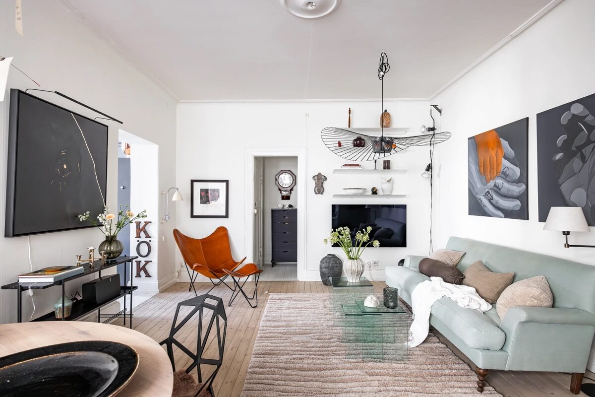 A Swedish Apartment with a Moody Kitchen and Bedroom 2 light living room with art and light blue sofa