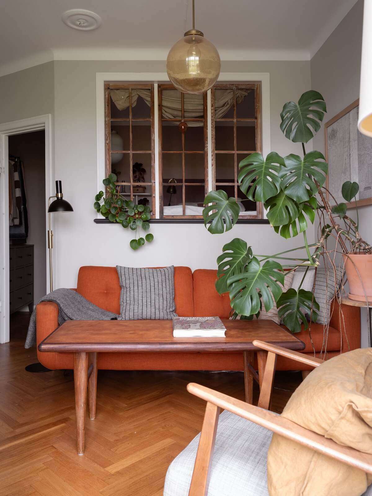 living room light gray walls burnt orange couch