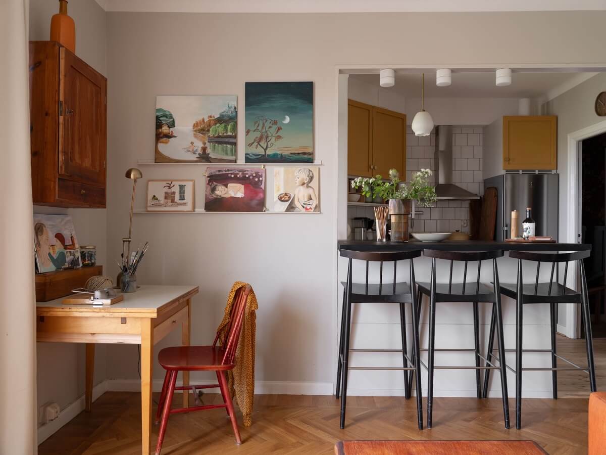 A Small Apartment with an Ochre Yellow Kitchen 8 living room with desk and bar seating