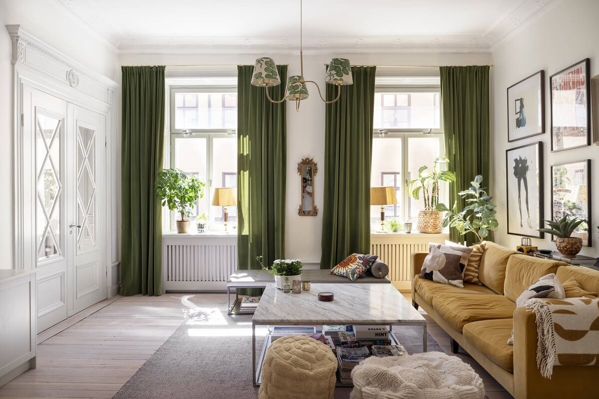 Bright, Spacious Rooms in a Classic Stockholm Apartment 6 living room with green sofa and curtains