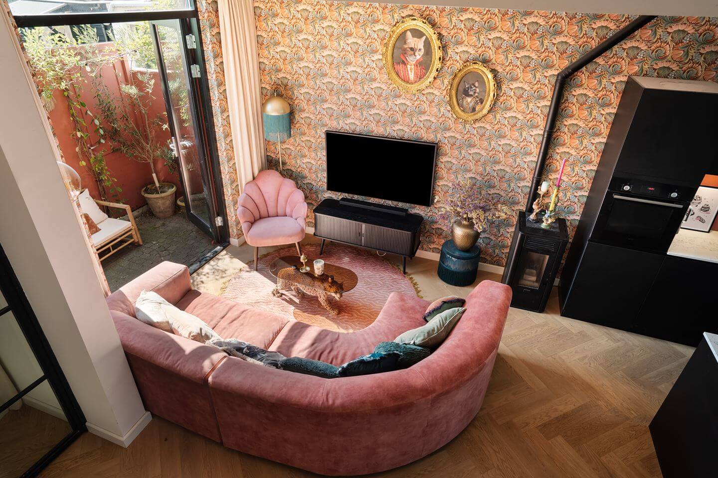 Rich Colors in a Charming Late 19th-Century Home in The Netherlands 2 living room with pink curved sofa wallpapered walls nordroom
