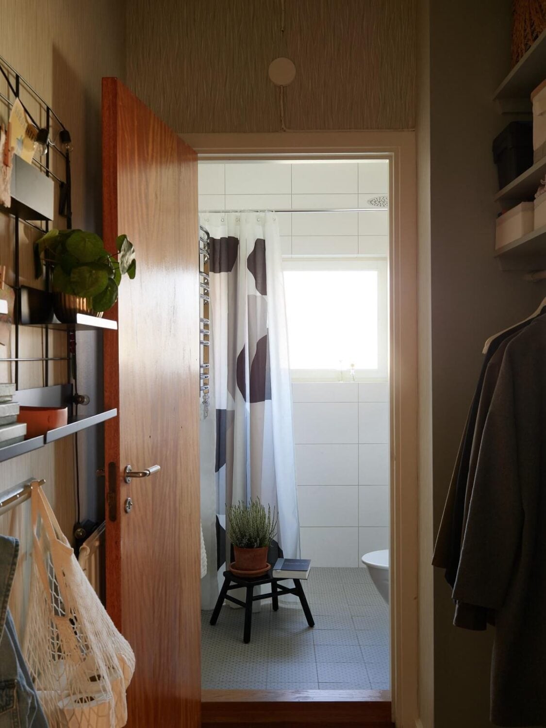 A Midcentury Swedish Apartment with Bold Colors 20 mdicentury home hallway bathroom A Midcentury Swedish Apartment with Bold Colors