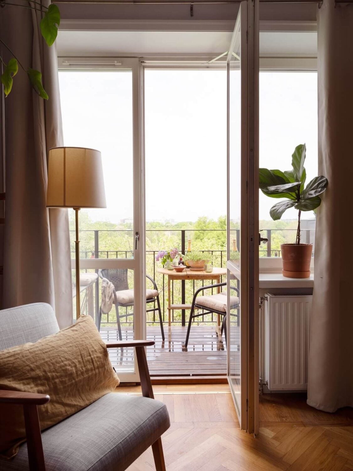 A Small Apartment with an Ochre Yellow Kitchen 5 midcentury ikea chair and balcony