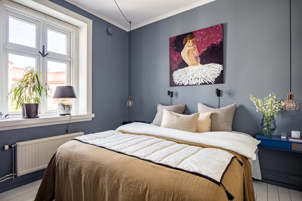 A Swedish Apartment with a Moody Kitchen and Bedroom 11 moody bedroom with ochre bedding and cobalt blue nightstand A Swedish Apartment with a Moody Kitchen and Bedroom