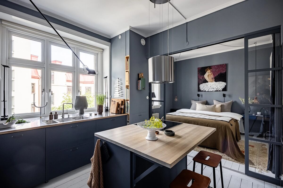 A Swedish Apartment with a Moody Kitchen and Bedroom 9 moody kitchen space with island A Swedish Apartment with a Moody Kitchen and Bedroom