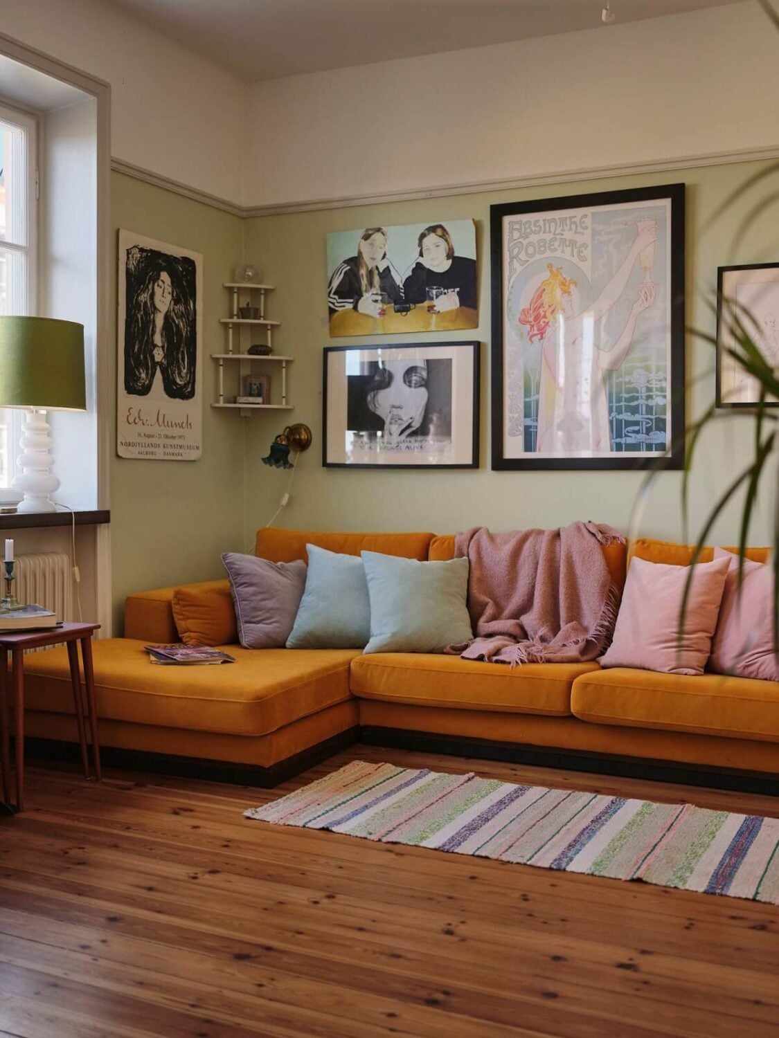 A Charming Small Two-Bedroom Apartment in Stockholm 2 ochre sofa and pale green walls