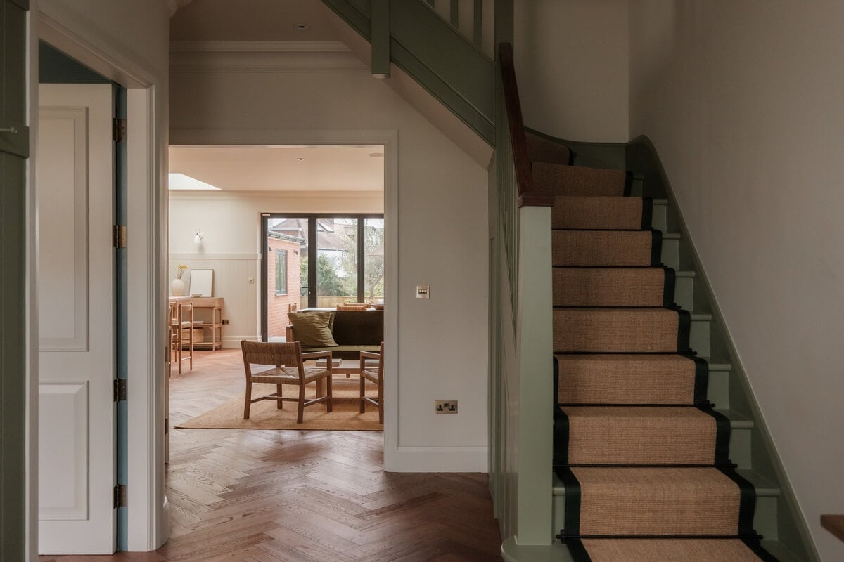 A Calm Color Palette and Warm Materials in a London Home 4 open hallway with green staircase