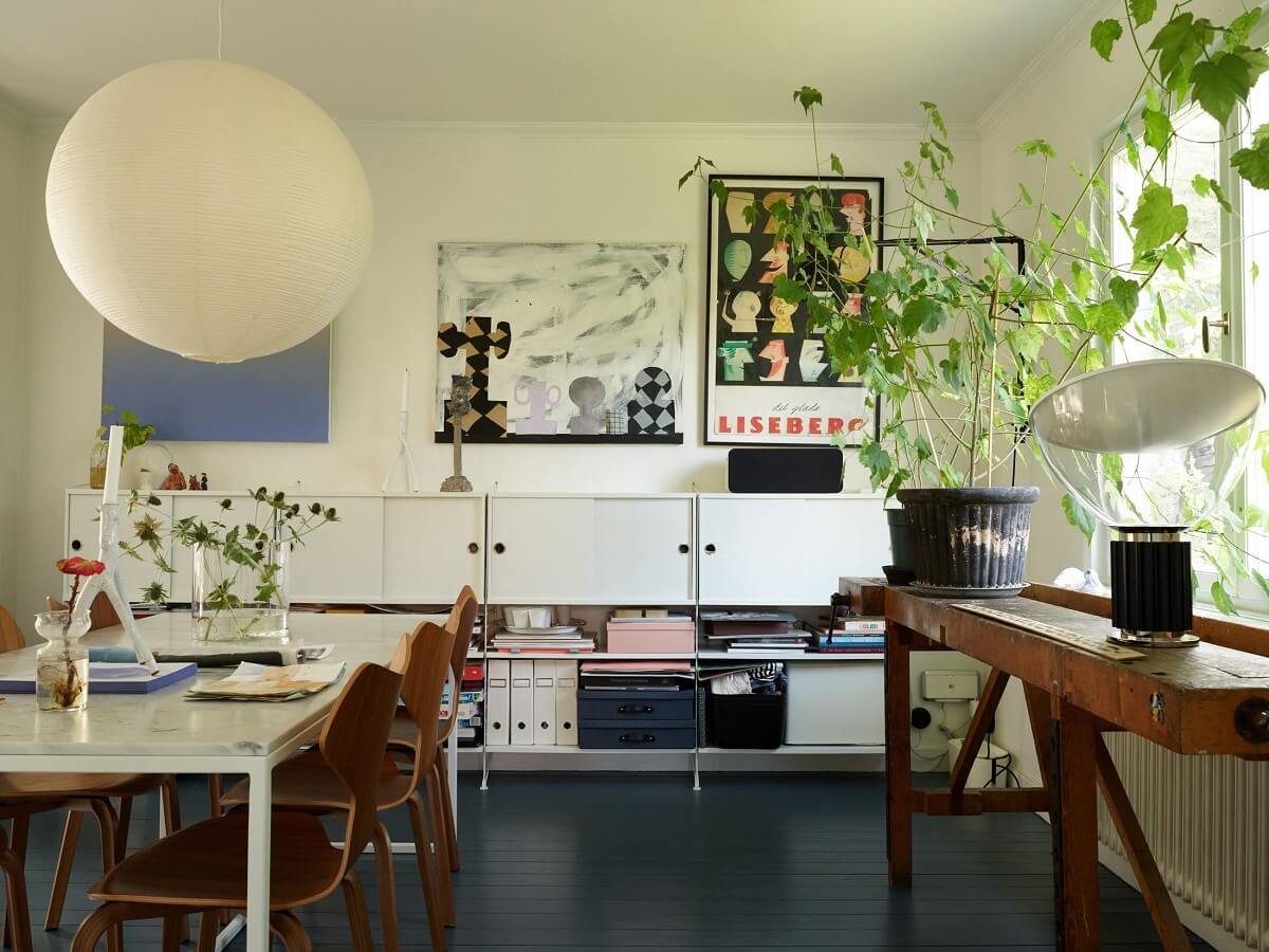 A 1940s House with Painted Floorboards in Sweden 7 open plan dining space with shelving system and blue floor