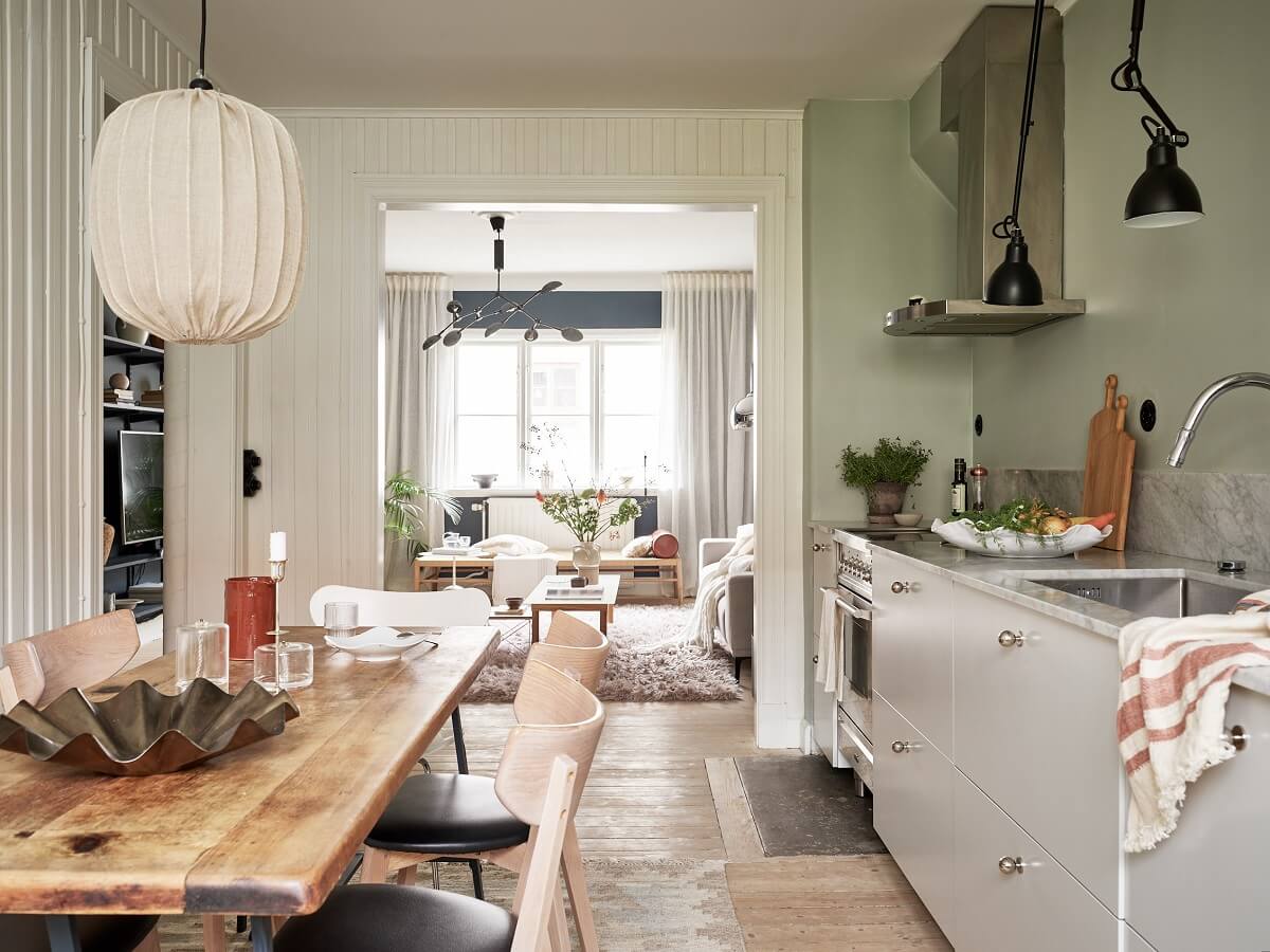 A Swedish Apartment with a Dark Blue Living Room and Exposed Brick 10 open plan kitchen living room