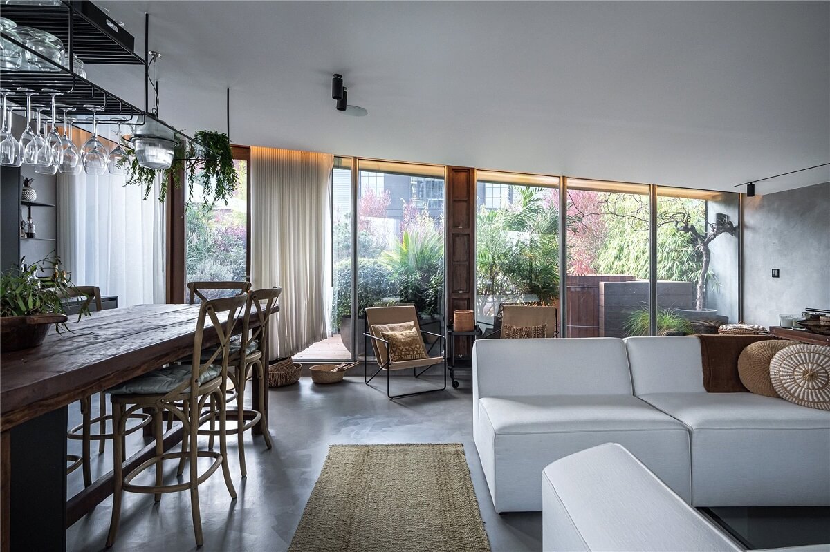 An Industrial, Loft-Style Duplex with Japanese Landscaped Roof Terraces 9 open plan living and kitchen with slanted ceiling and glass wall