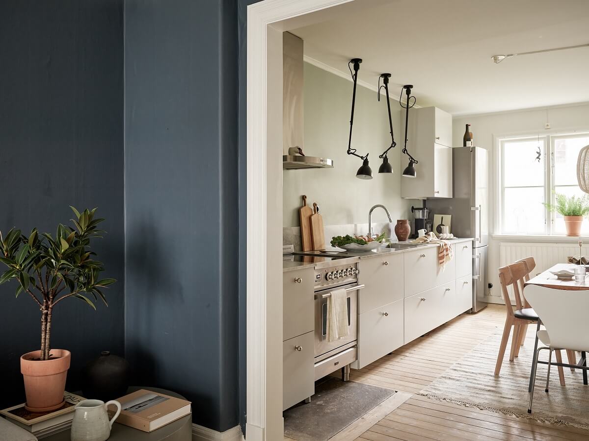 A Swedish Apartment with a Dark Blue Living Room and Exposed Brick 6 open plan living room and kitchen