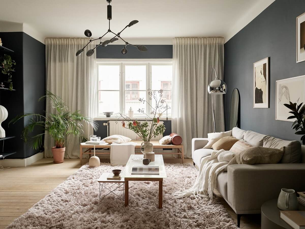 A Swedish Apartment with a Dark Blue Living Room and Exposed Brick 1 open plan living room dark walls light furnishings