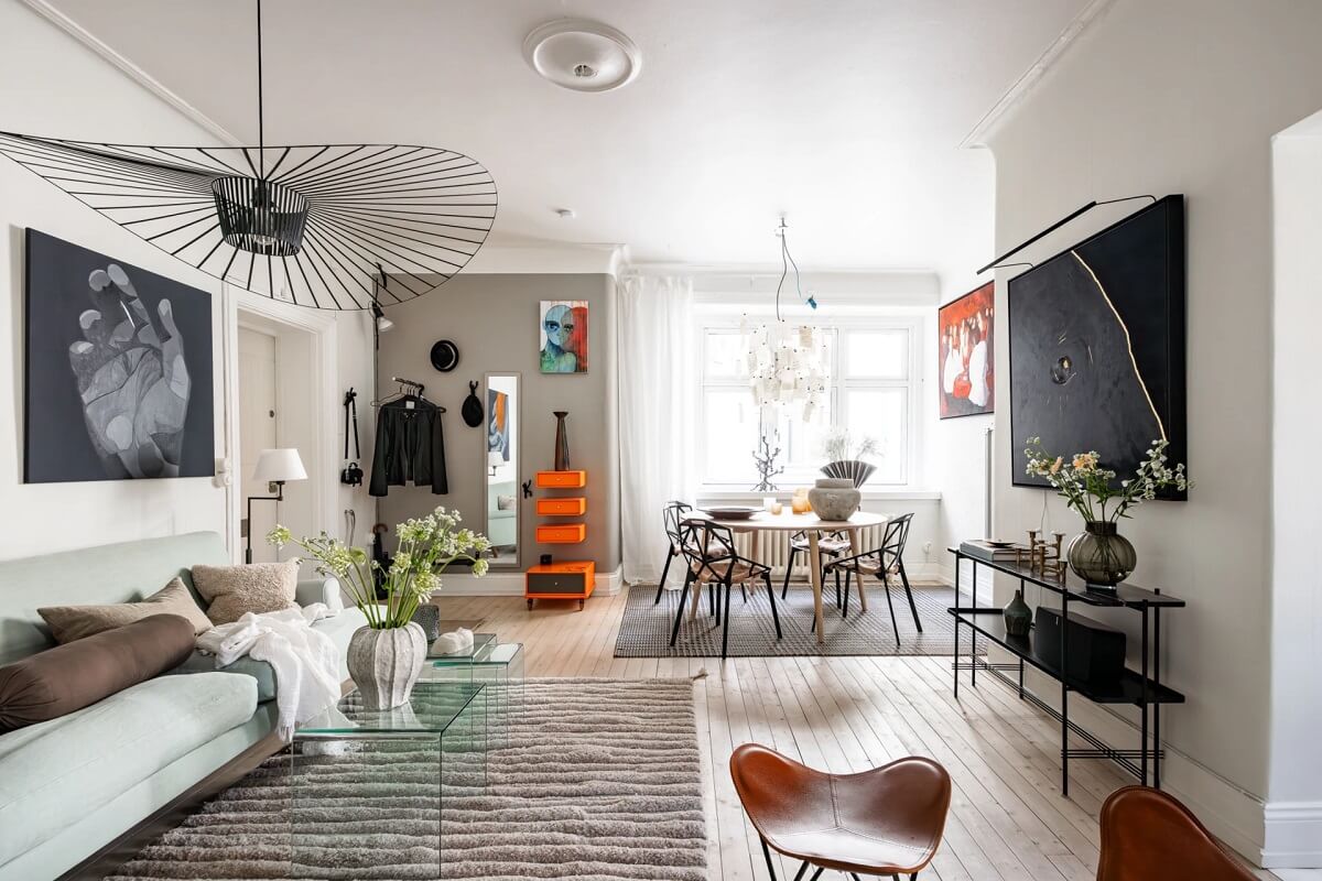 A Swedish Apartment with a Moody Kitchen and Bedroom 1 open plan living room with blue sofa and large rug