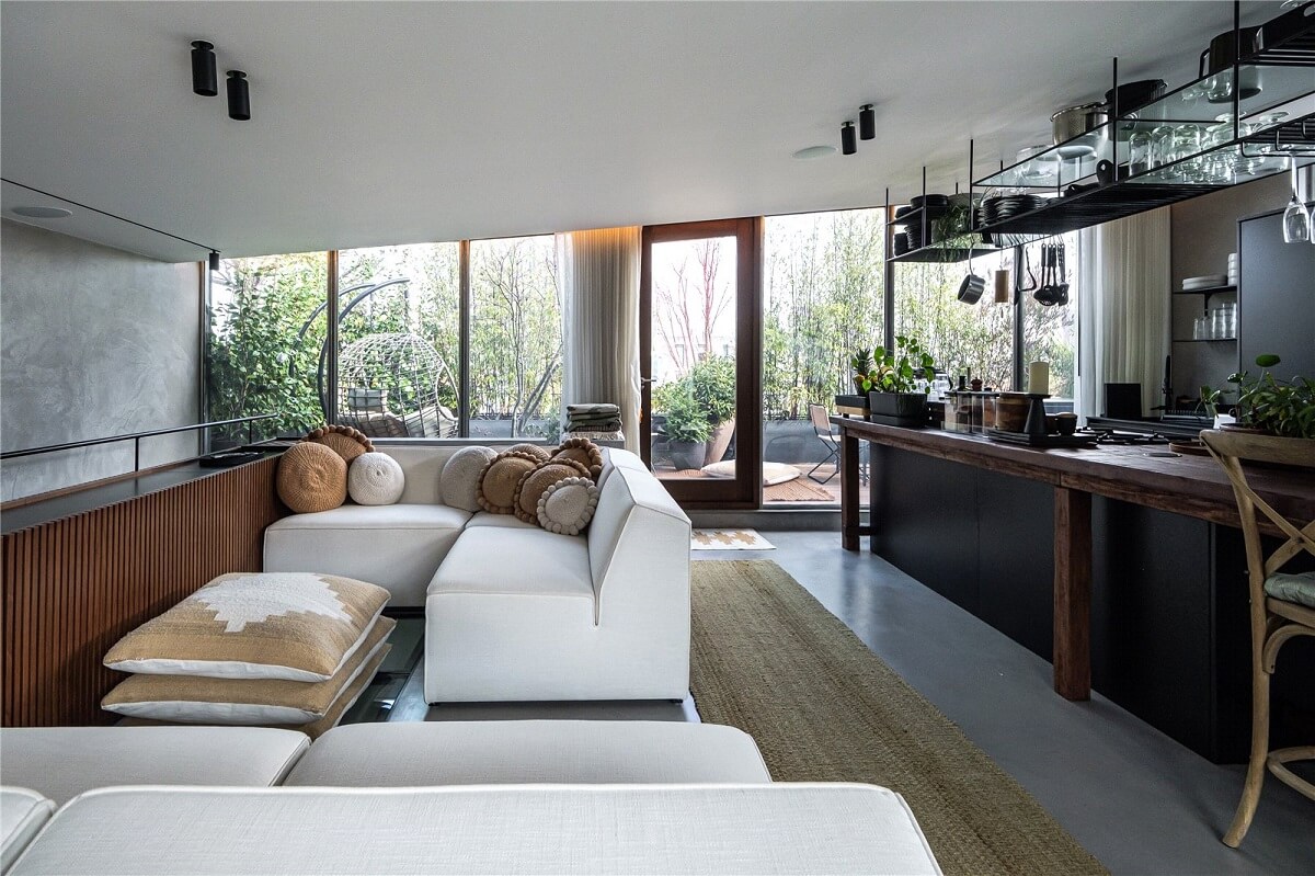 An Industrial, Loft-Style Duplex with Japanese Landscaped Roof Terraces 8 open plan sitting room and kitchen with black cabinets