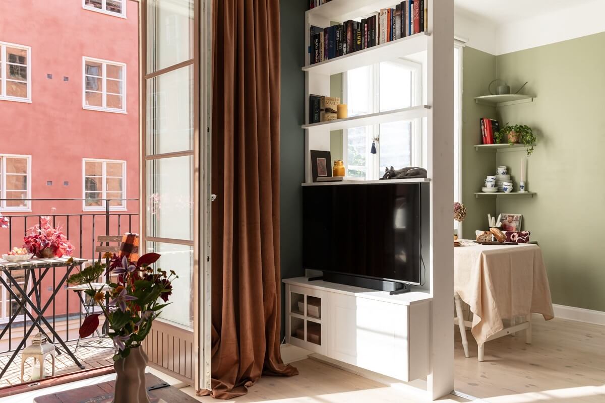 A Stockholm Studio Apartment with Warm Earthy Textiles 12 open tv storage and bookshelves