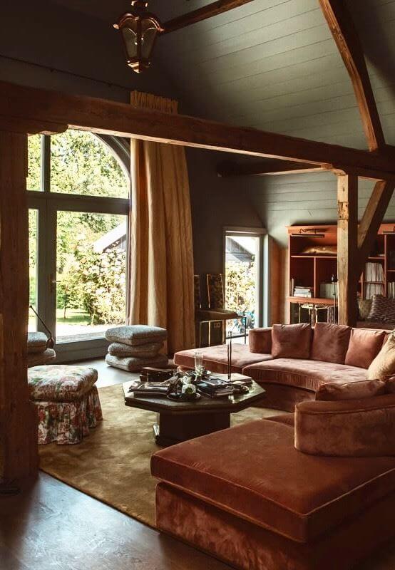 An Eclectic Colorful House in an Old Dutch Farmhouse 20 pitched ceiling living room wooden beams pink sofa