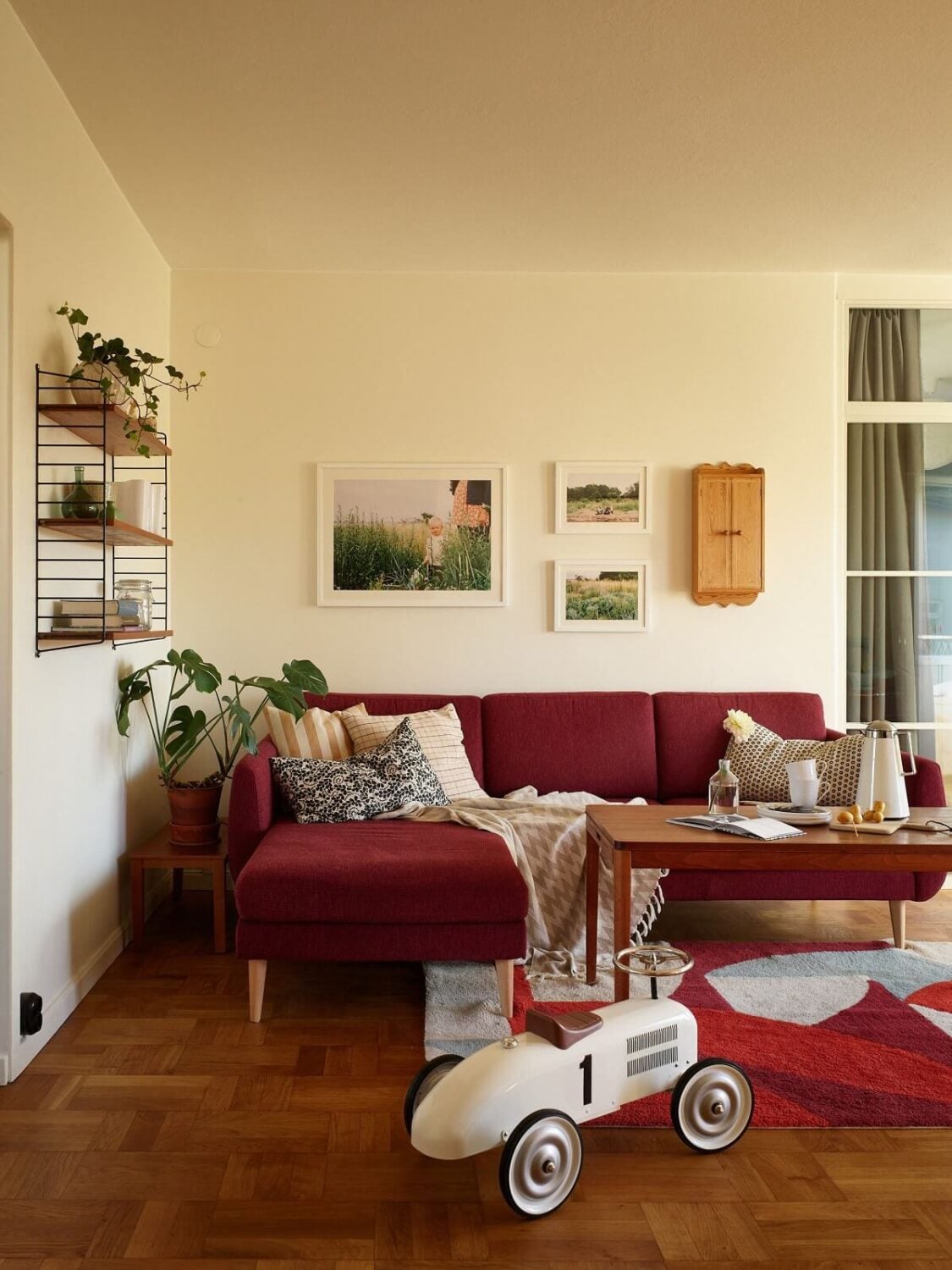 A Midcentury Swedish Apartment with Bold Colors 2 red sofa living room