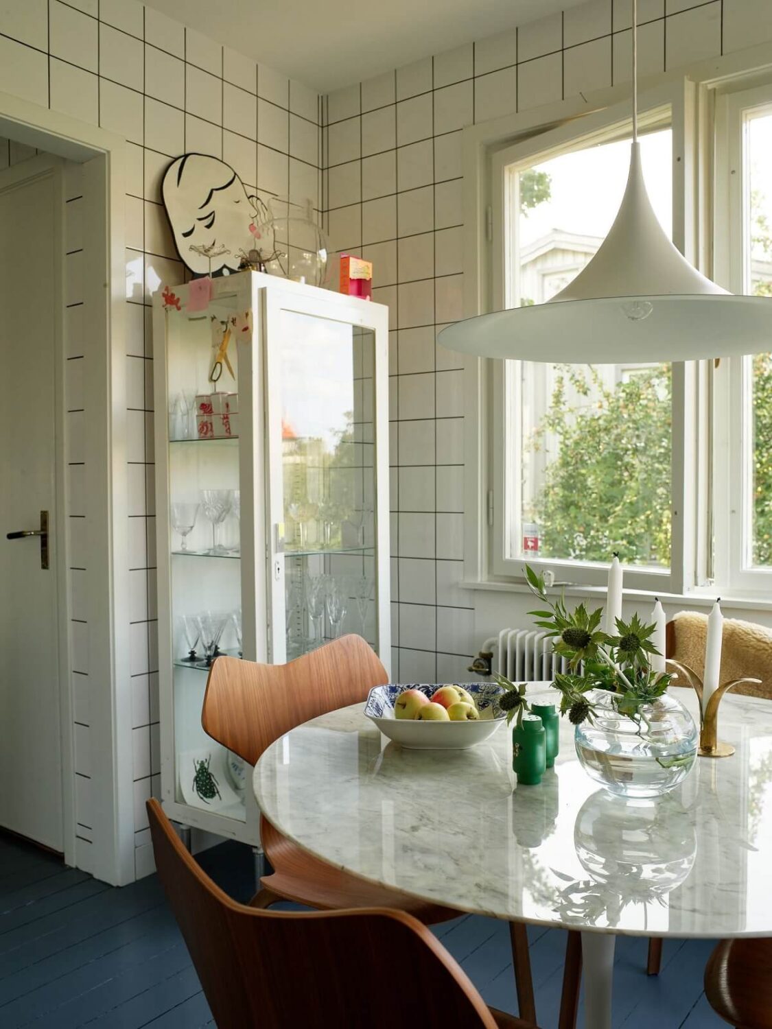A 1940s House with Painted Floorboards in Sweden 10 round dining table and white square tiles to the ceiling