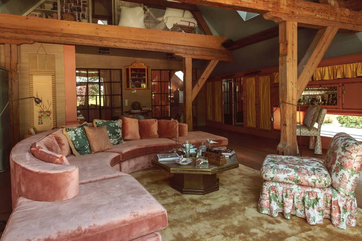round pink sofa living room pitched ceiling wooden beams