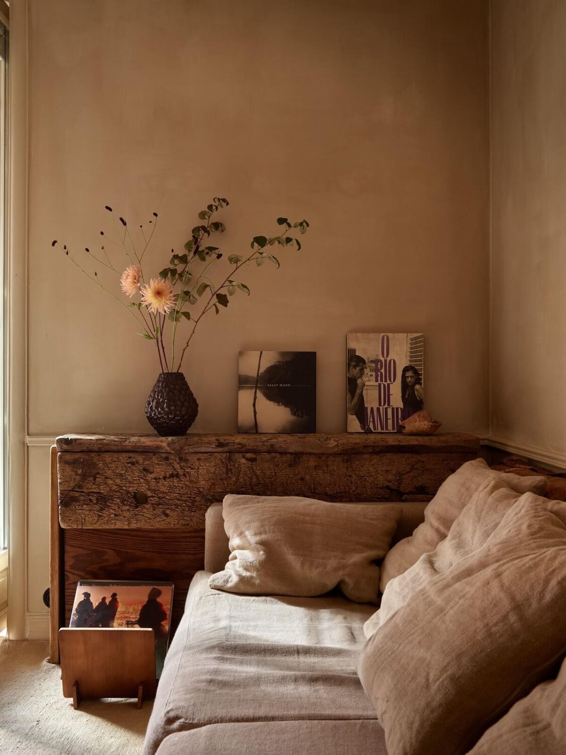A Studio Apartment with Plaster Walls and a Walnut Kitchen 4 rustic wooden side table