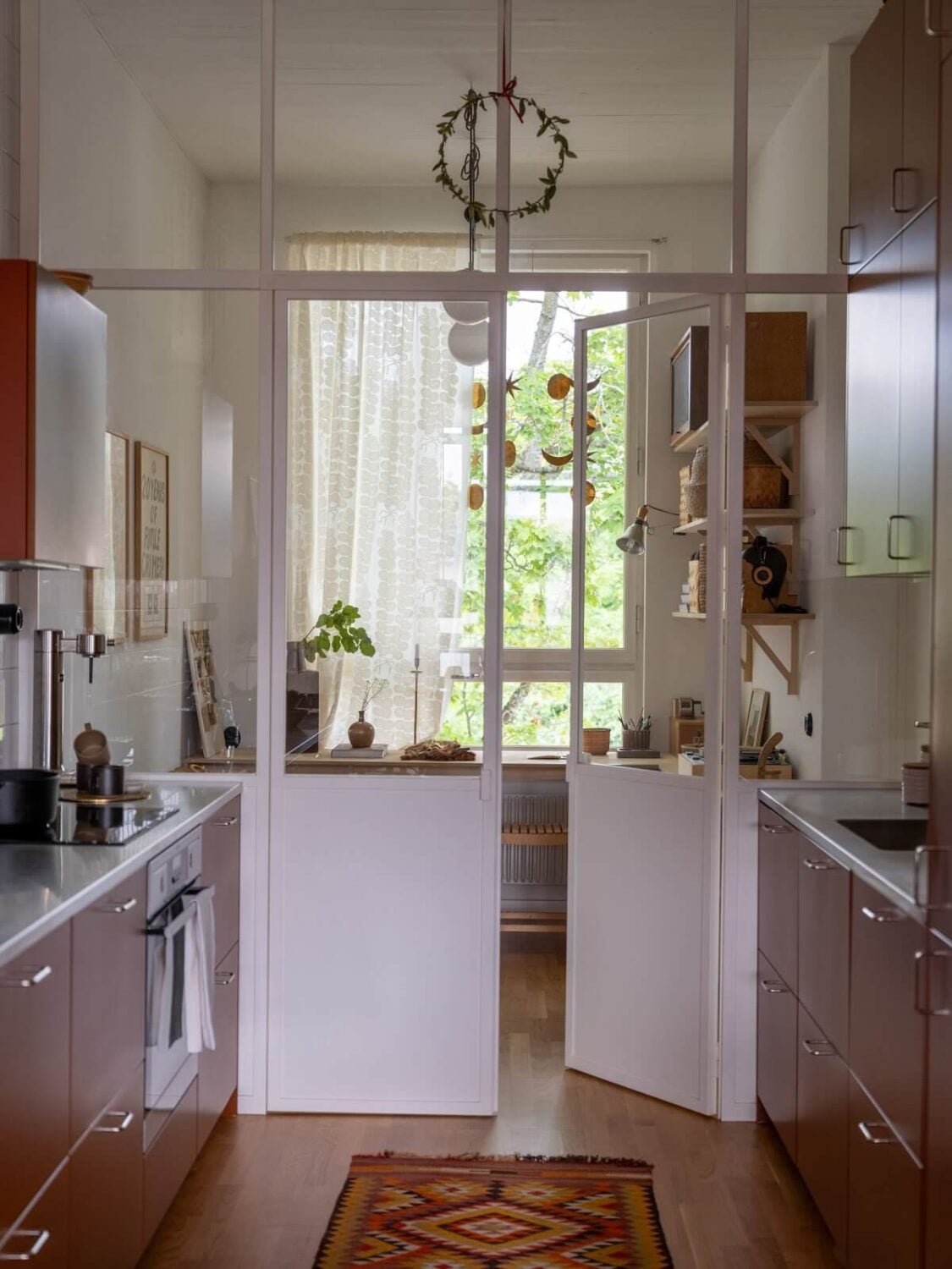 A Scandinavian Family Apartment with a Rusty Red Kitchen 13 rusty red kitchen with white doors