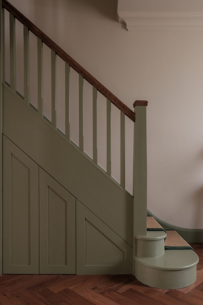 A Calm Color Palette and Warm Materials in a London Home 17 sage green staircase
