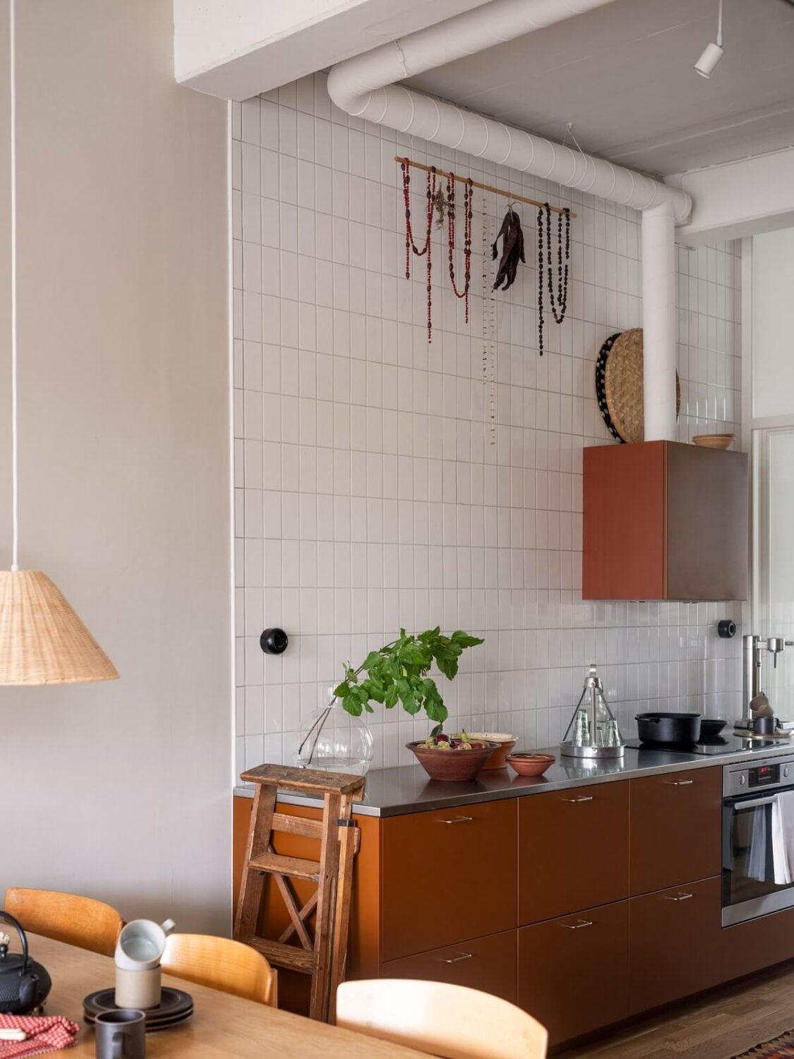 A Scandinavian Family Apartment with a Rusty Red Kitchen 6 scandi home rusty red kitchen cabinets high ceilings
