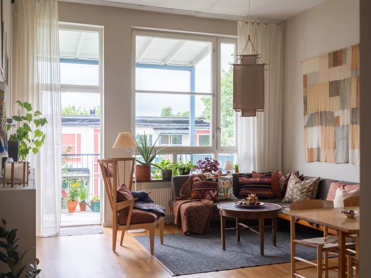 A Scandinavian Family Apartment with a Rusty Red Kitchen 2 scandi living room with balcony