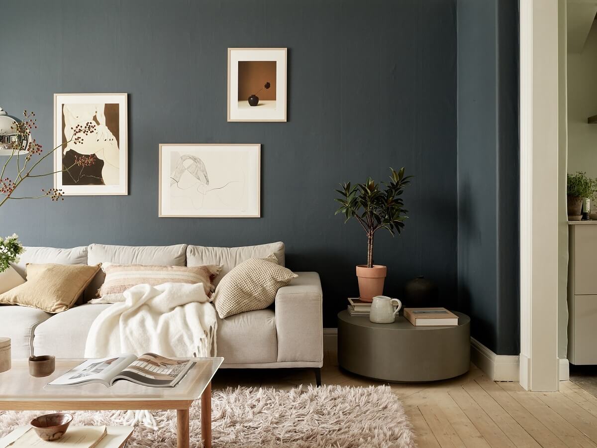 A Swedish Apartment with a Dark Blue Living Room and Exposed Brick 2 scandi living roomwith round side table