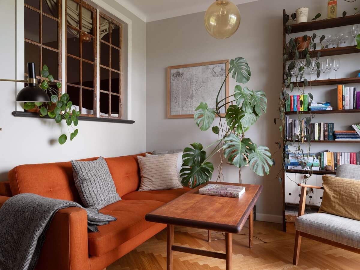 A Small Apartment with an Ochre Yellow Kitchen 2 small living room with antique window and burnt orange sofa