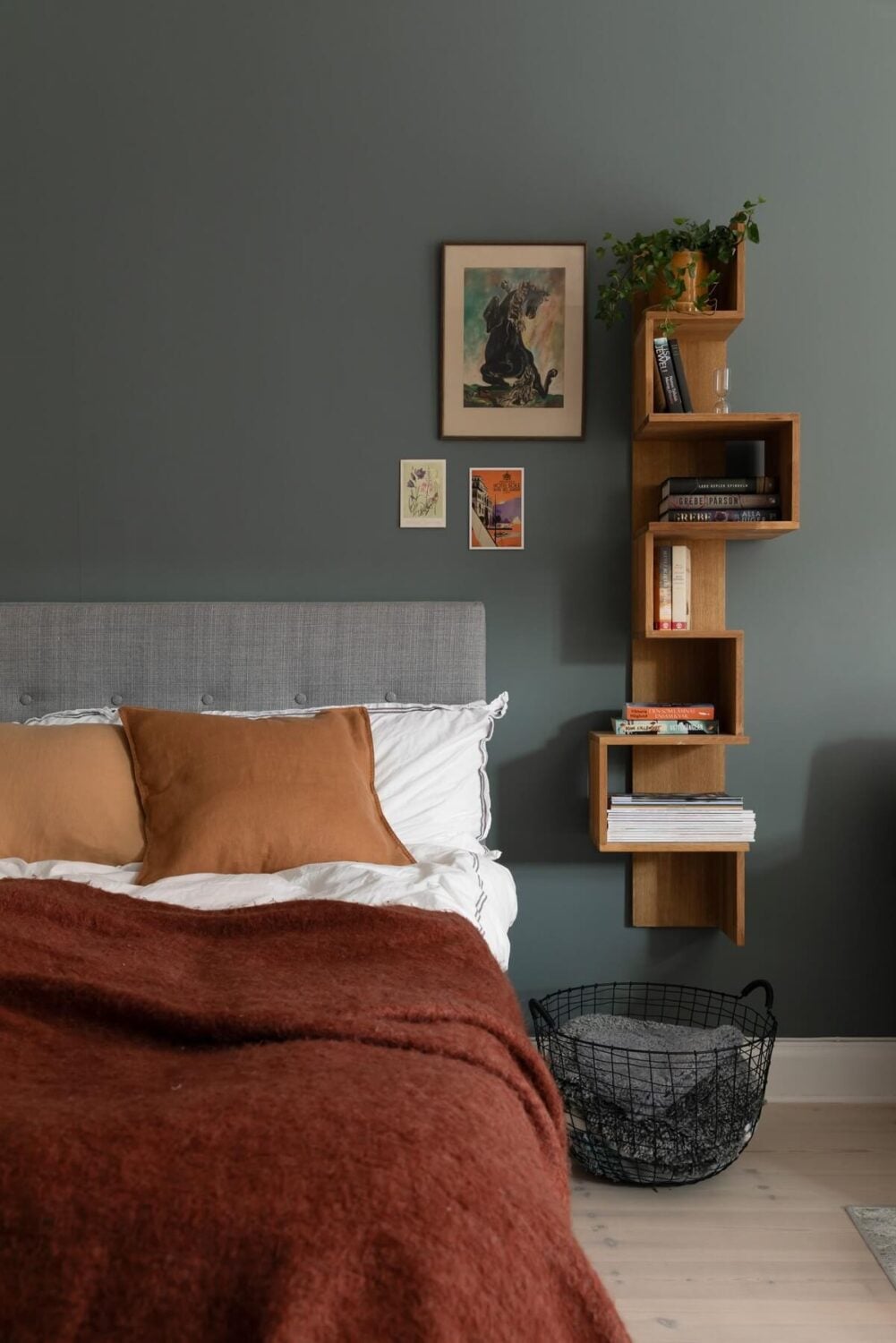 A Stockholm Studio Apartment with Warm Earthy Textiles 9 studio bed with wall mounted bookcase