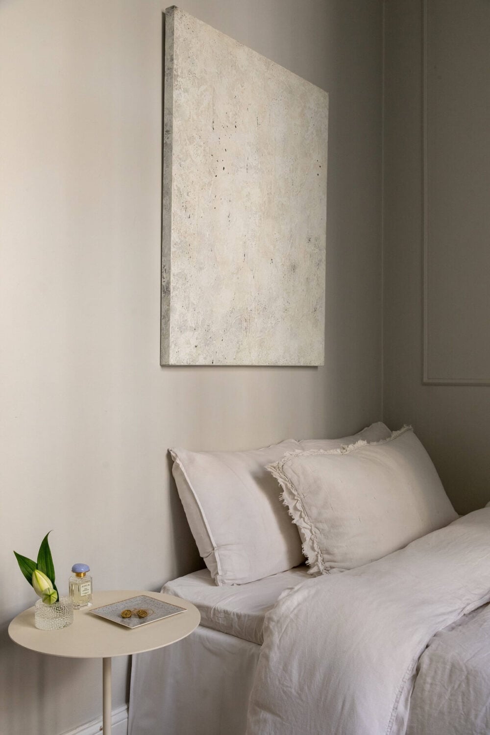 A Tiny Minimalistic Apartment in Stockholm 10 tiny gray bedroom with neutral art