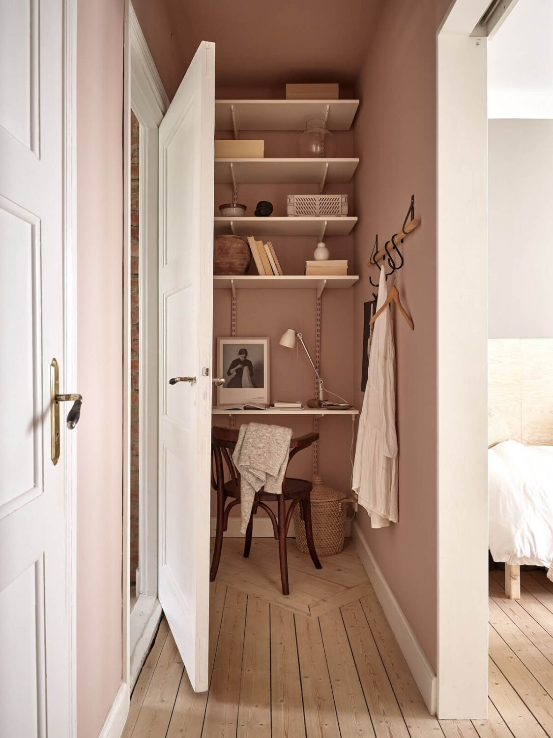 A Swedish Apartment with a Dark Blue Living Room and Exposed Brick 15 tiny pink home office