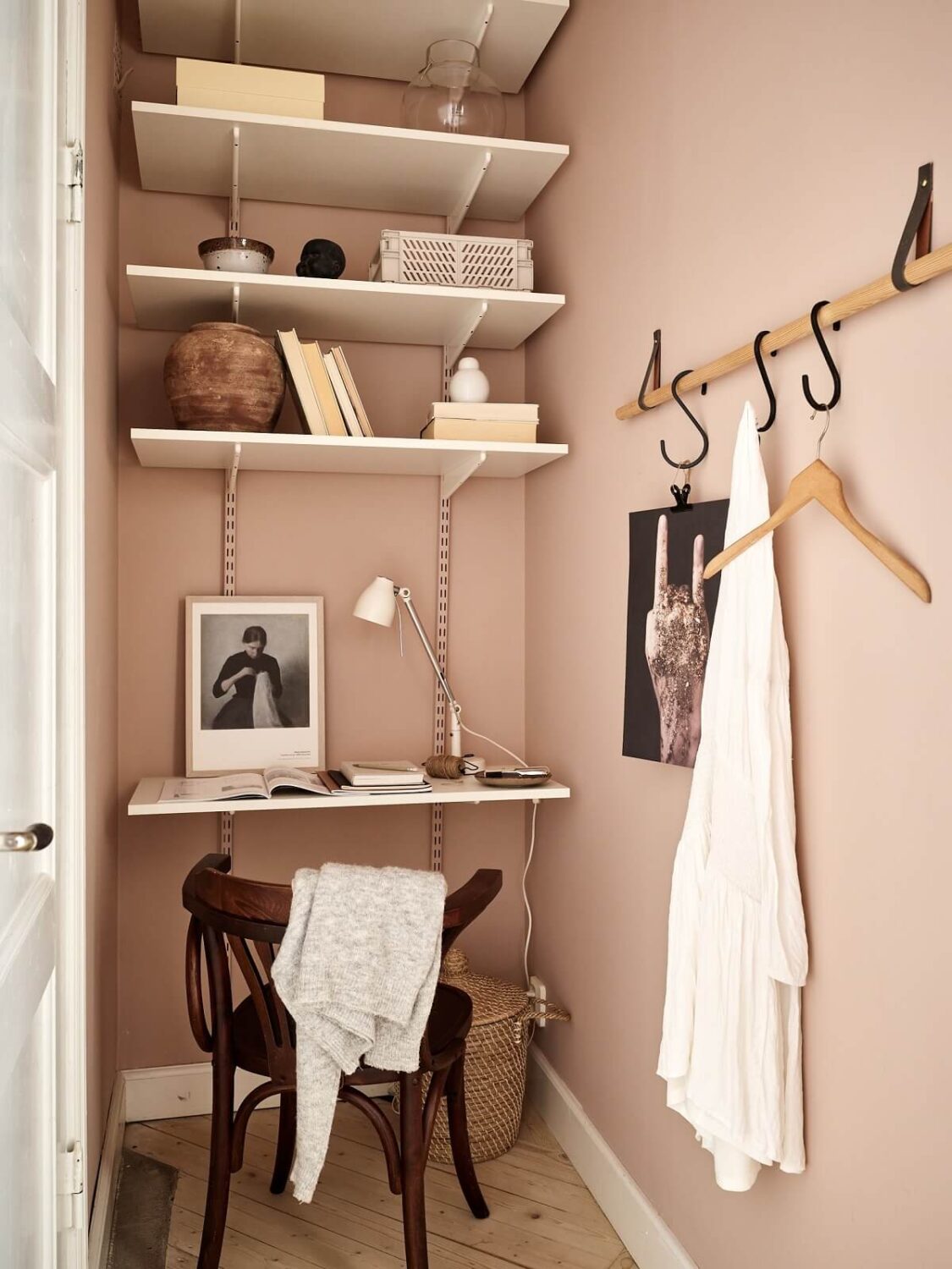 A Swedish Apartment with a Dark Blue Living Room and Exposed Brick 16 tiny pink home office with shelves