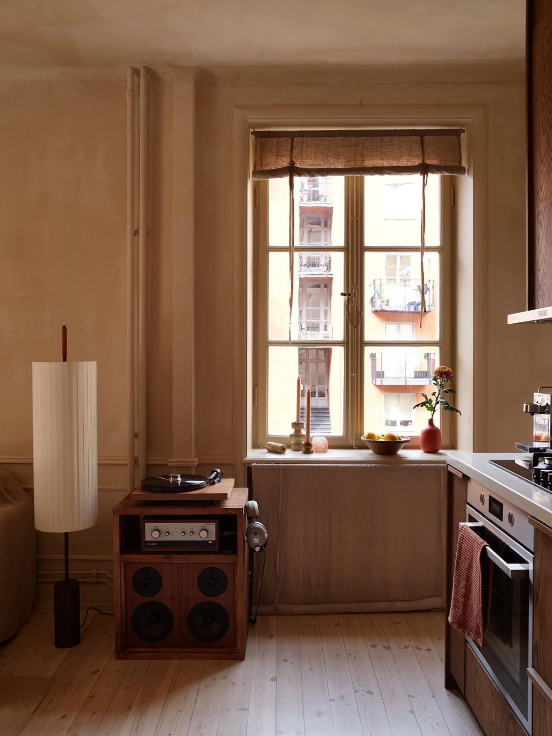 A Studio Apartment with Plaster Walls and a Walnut Kitchen 10 tiny studio kitchen with walnut cabinets