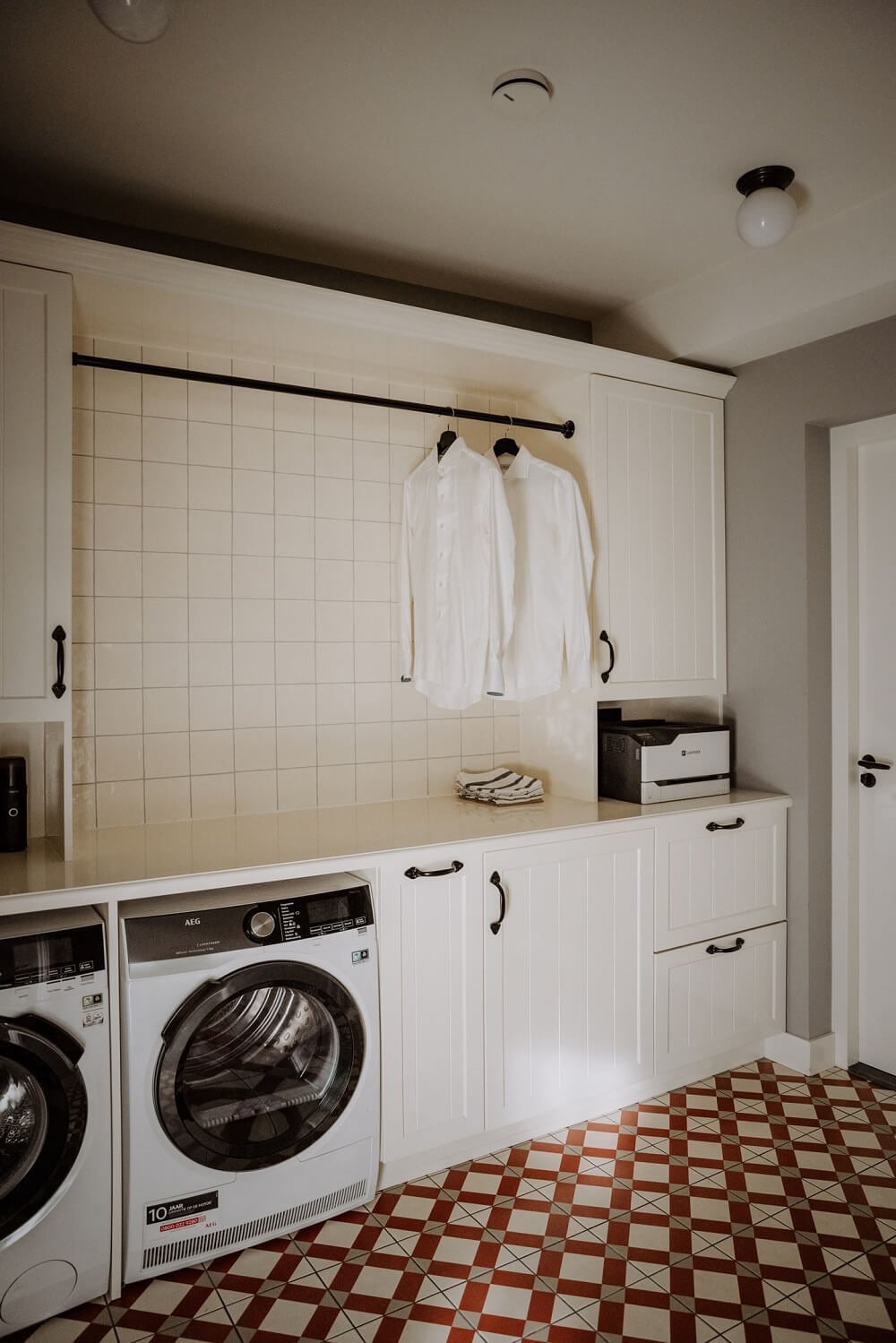 Historic Charm in a New Country House in The Netherlands 10 utility room with classic floor tiles