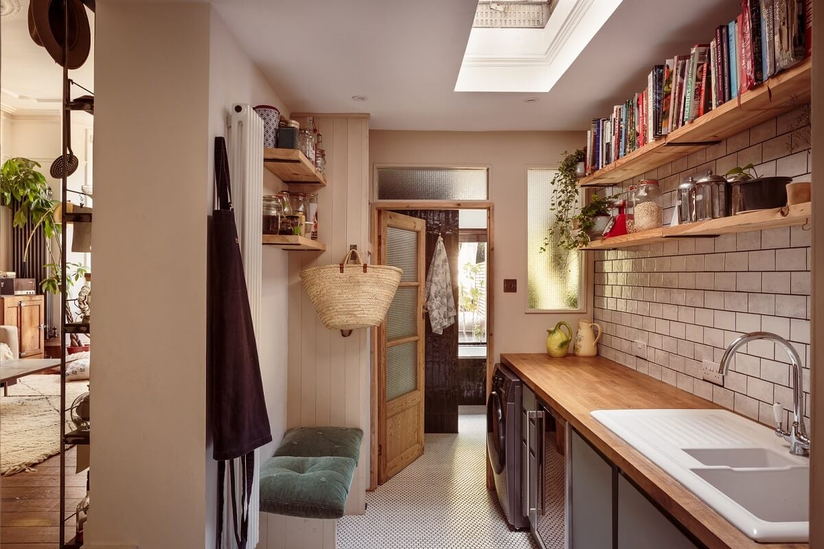 A Warm Ground Floor Apartment with Reclaimed Materials 8 utility room with white brick wall and shelves
