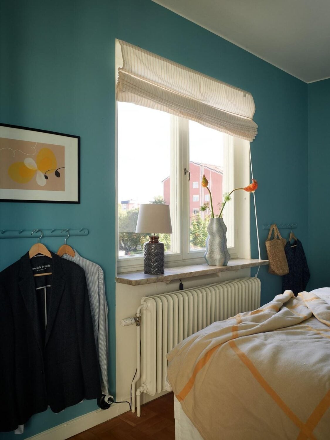 A Midcentury Swedish Apartment with Bold Colors 14 vibrant blue bedroom