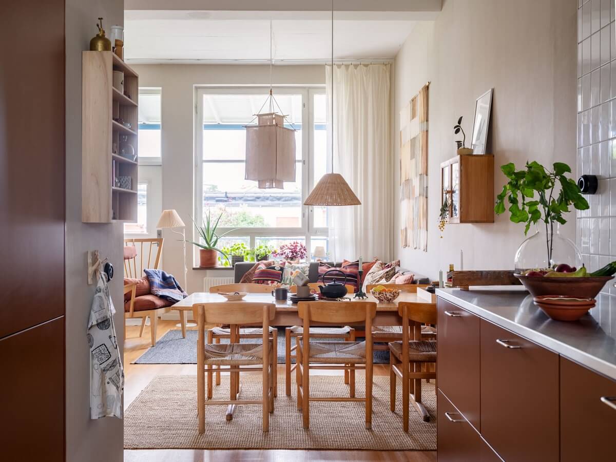 A Scandinavian Family Apartment with a Rusty Red Kitchen 8 view into living room