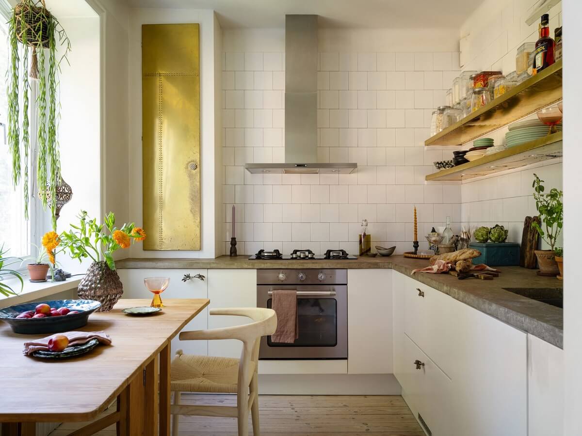 A Light and Well-Planned Apartment in Stockholm 10 white kitchen concrete worktops gold accents