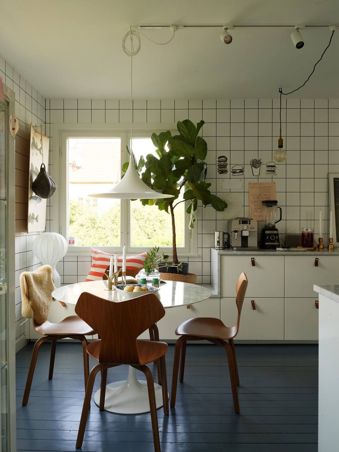 A 1940s House with Painted Floorboards in Sweden 8 white kitchen with tiles to the ceiling and blue wooden floor nordroom