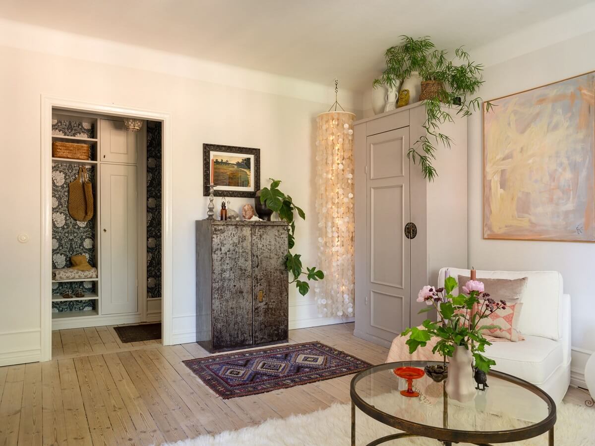 A Light and Well-Planned Apartment in Stockholm 7 white living room built in cabinet