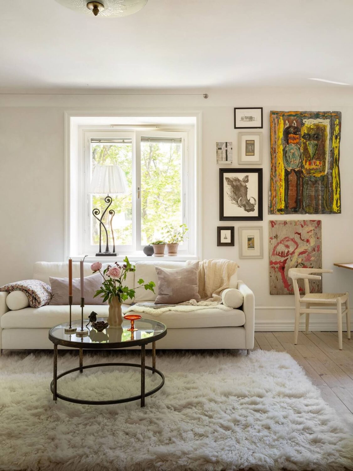 A Light and Well-Planned Apartment in Stockholm 2 white living room with gallery wall