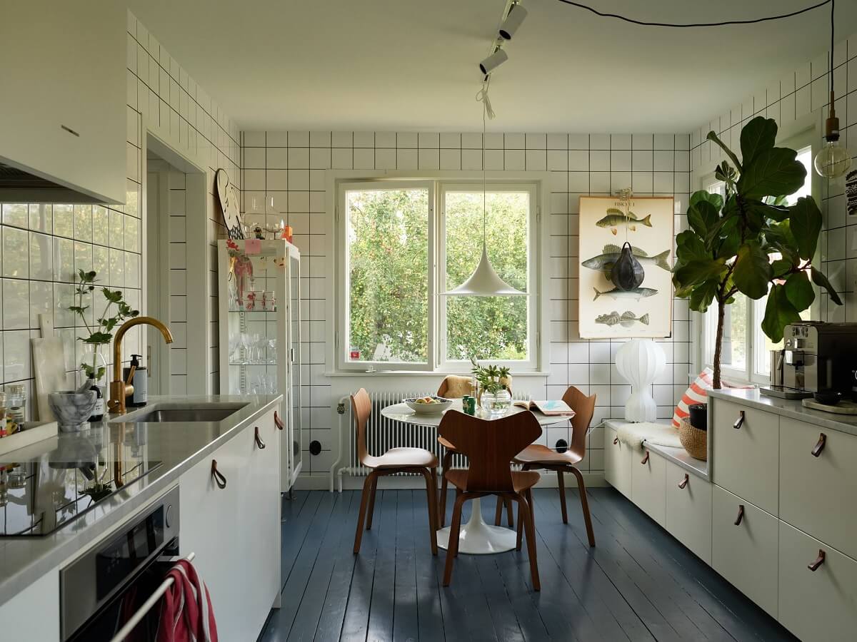 A 1940s House with Painted Floorboards in Sweden 11 white scandinavian kitchen with blue floor and round table
