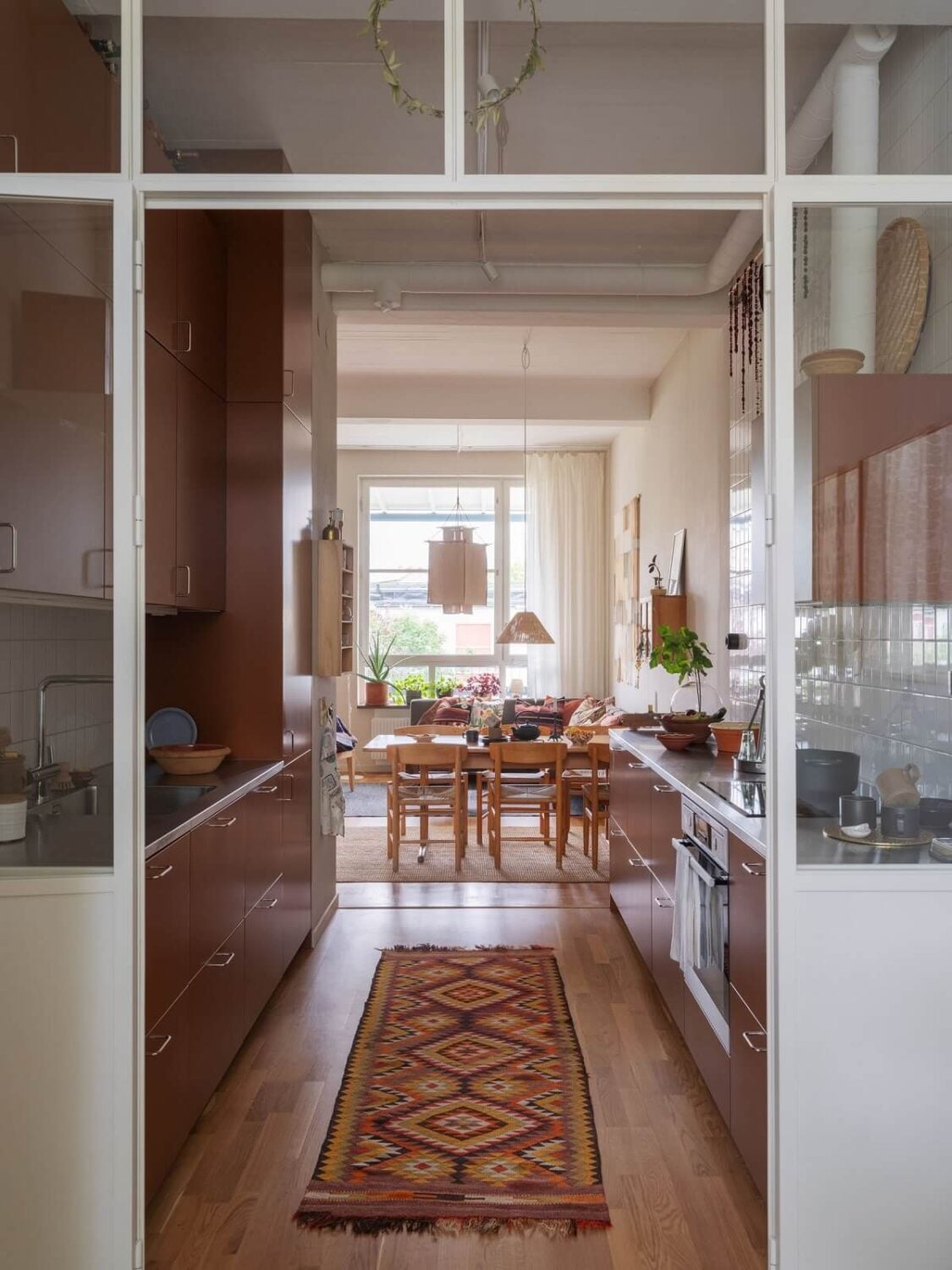 A Scandinavian Family Apartment with a Rusty Red Kitchen 12 white steel glass doors kitchen