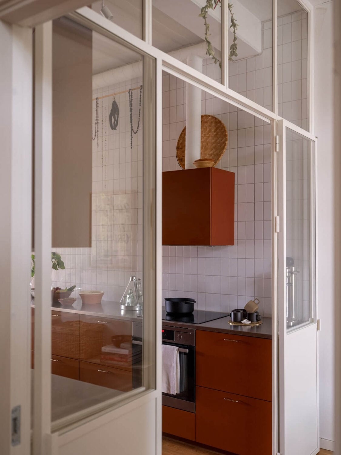 A Scandinavian Family Apartment with a Rusty Red Kitchen 11 white steel glass wall rusty red kitchen nordroom
