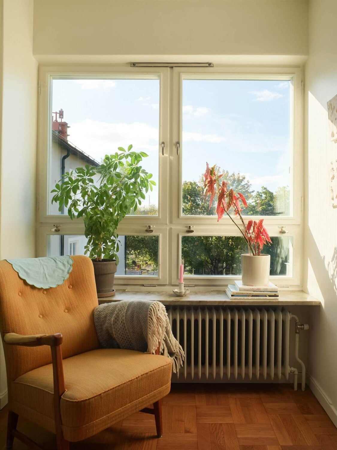A Midcentury Swedish Apartment with Bold Colors 4 window seat ochre chair