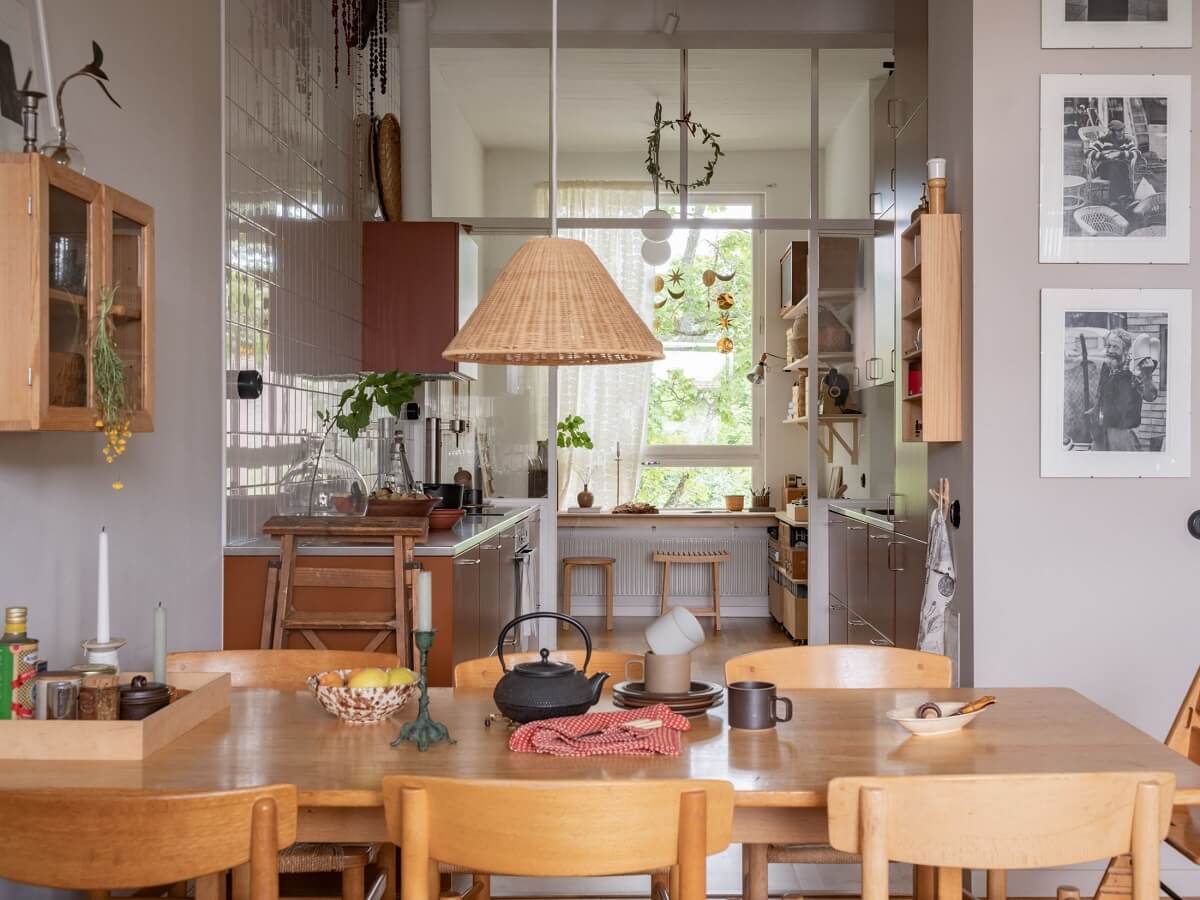 A Scandinavian Family Apartment with a Rusty Red Kitchen 7 wooden dining table